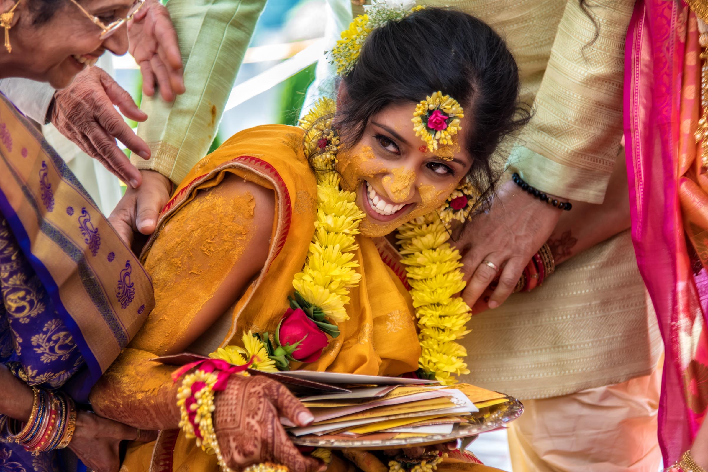 Wedding Photographer in North Carolina capturing candid wedding moment of Indian Bride during her Pithi Ceremony